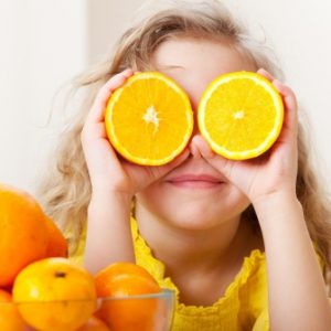 14697853 - child with oranges. happy little girl with fruit at home.